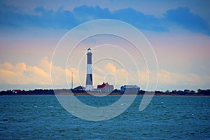 Fire Island Lighthouse with beaming light on Long Island Sound, New York