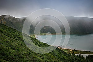 Fire Lagoon caldera with green vegetation on the hill and fog on top, SÃ£o Miguel - Azores PORTUGAL photo