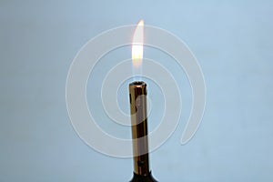 Fire from a lighter on a gray background.