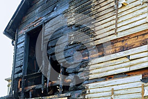 Fire line in front of a destroyed home. burnt house after fire