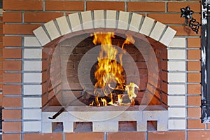 The fire is lit in a summer brick oven for barbecue, grill and other outdoor dishes