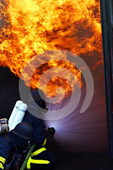 Fire men in action burning building