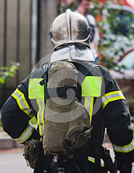 Fire men in protective uniform during fire fighting operation in the city streets, firefighters brigade with the fire