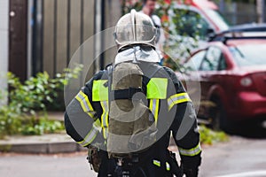 Fire men in protective uniform during fire fighting operation in the city streets, firefighters brigade with the fire