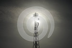 Fire observation and cell tower against the backdrop of the sun. Dahab, South Sinai Governorate, Egypt