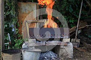 a fire in an old brazier in a dump of things