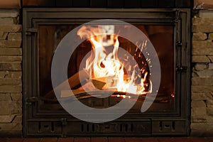 Fire in an old cast iron fireplace. Fire in the form of a human face.