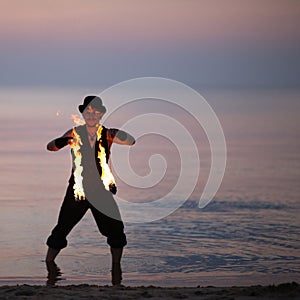 Fire performer in the sea water