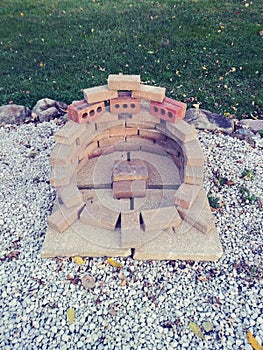 fire pit concept. bricks stacked arranged in a circular shape four concrete slabs