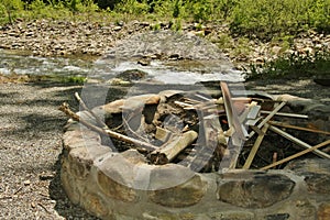 Fire Pit near River filled with Wood