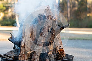 A Fire Pit with Smokey Stacked Logs