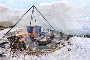 A fire pot using for cooking fish soup during camping on lake Baikal, Russia.