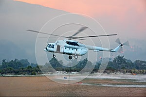 Fire rescue helicopter refills water tank