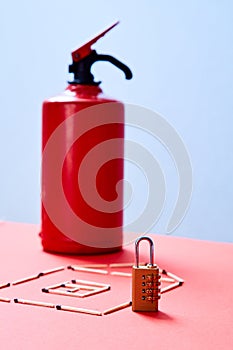 Fire safety, or security and protection concept. A fire extinguisher, the figure of the house and lock