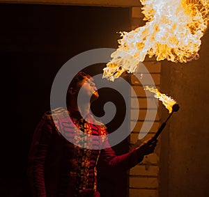 Fire show artist breathe fire in the dark