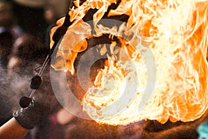 Fire show artist breathe fire in the dark jamp photo