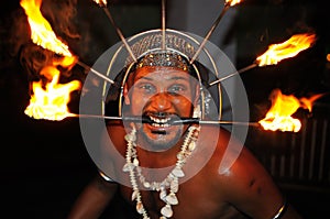 Fire show. Fakir takes a risky trick with burning torches in Galle