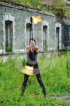 Fire show girl with flaming torches