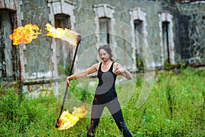 Fire show girl with flaming torches