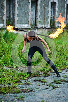 Fire show girl with flaming torches