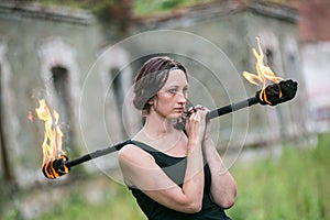 Fire show girl with flaming torches