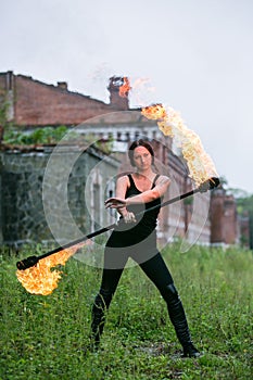 Fire show girl with flaming torches