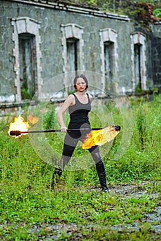 Fire show girl with flaming torches