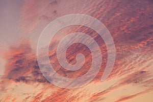 Fire sky background. Soft clouds with the hint of the sun at sunset. Many orange tones and patterns of clouds