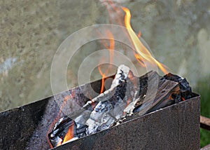 Fire and smoke. Barbecue firewood. Grill for frying meat. Bonfire on a picnic. Hot coals.