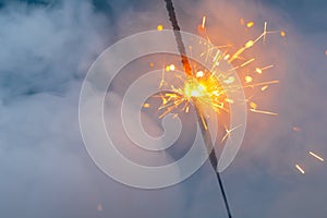 Fire sparkler in dense smoke, abstract Christmas firework background