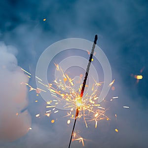 Fire sparkler in dense smoke, abstract Christmas firework background