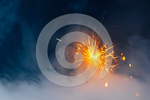 Fire sparkler in dense smoke, abstract Christmas firework background