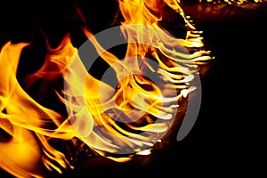 Fire and sparks, from a campfire on a dark night background, front and background blurred