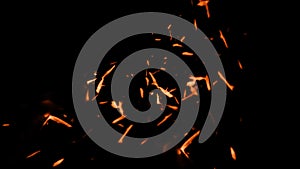 Fire sparks flying up. Glowing particles on a dark background textire for text or space