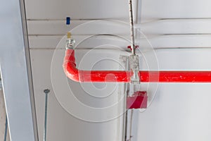 Fire sprinkler and red pipe installed on ceiling for safety concept