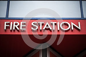 Fire station metal sign against bright red background