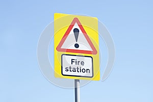 Fire station sign blue background sky yellow red white direction emergency services brigade serviceman uk