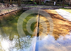 Fire tank in small villages served as a place for bathing ducks and geese plank descent to water is gradual due to poultry