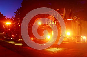Fire truck with flashing emergency warning lights response scene on a street at night