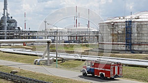 Fire truck in industrial plant. A large red fire rescue vehicle in the chemistry refinary plant