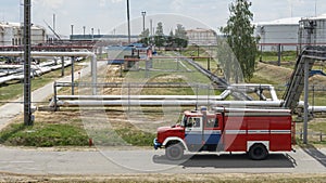 Fire truck in industrial plant. A large red fire rescue vehicle in the chemistry refinary plant. Fire safety concept