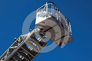 Fire truck ladder with basket on blue sky background