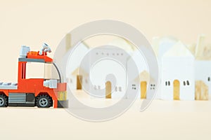 Fire truck plastic toy with village background