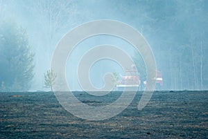 A fire truck stands by the forest