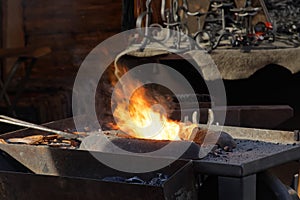 Fire used by the blacksmith in the forge