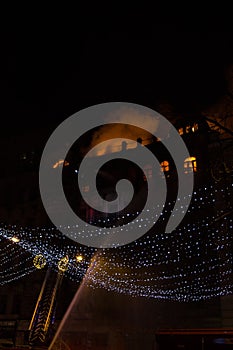 Fire in the windows of the old building at night in winter against the background of garlands. fire extinguishing. Kiev, January