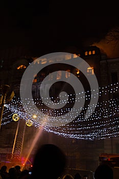 Fire in the windows of the old building at night in winter against the background of garlands. fire extinguishing. Kiev, January