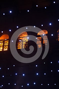 Fire in the windows of the old building at night in winter against the background of garlands. fire extinguishing. Kiev, January