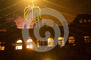 Fire in the windows of the old building at night in winter against the background of garlands. fire extinguishing. Kiev, January