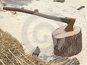 Fire wood log and old rusty axe